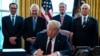 President Donald Trump signs the coronavirus stimulus relief package in the Oval Office at the White House in Washington, March 27, 2020.