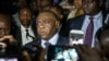 FILE - Congolese opponent Jean-Pierre Bemba, center, speaks to the press after applying to be a candidate for next presidential elections of December 23, at the office of the Independent Electoral Commission, in Kinshasa, Aug. 2, 2018.