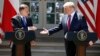 President Donald Trump and Polish President Andrzej Duda reach to shake hands at a news conference in the Rose Garden of the White House, in Washington, June 12, 2019. 