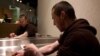FILE - Richard Chenery injects heroin he bought on the street at the Insite safe injection clinic in Vancouver, B.C., Canada.