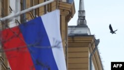 FILE - This photograph shows a Russian flag next to the US embassy building in Moscow, on March 7, 2024.