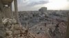 Syrians gather amidst destruction in Zardana, in the mostly rebel-held northern Syrian Idlib province, in the aftermath of airstrikes in the area, June 8, 2018.