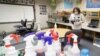 FILE - A teacher cleans a classroom in Indianapolis, June 22, 2020. Schools are making plans for students to return to classes, but with questions remaining about how instruction will happen.