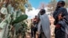 People mourn in front of a mass grave the victims of a massacre allegedly perpetrated by neighbouring Eritrean Soldiers in the village of Dengolat, North of Mekele, the capital of Tigray on February 26, 2021.
