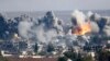 Smoke rises over Syrian town of Kobani after an airstrike, as seen from the Mursitpinar border crossing on the Turkish-Syrian border in the southeastern town of Suruc, in Sanliurfa province, Oct. 18, 2014. 