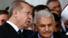 Turkey's President Recep Tayyip Erdogan (L) talks to Turkey's Prime Minister Binali Yildirim (R) as they attend the inauguration ceremony of the Melike Hatun mosque in Ankara, Turkey, Oct. 27, 2017. 