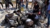 This photo provided by the Syrian Civil Defense White Helmets shows civil defense workers searching in the rubble after airstrikes hit in Khan Sheikhoun, in the northern province of Idlib, Syria, Sept, 24, 2017.