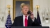President Donald Trump adjusts the microphone to speak about the partial government shutdown, immigration and border security in the Diplomatic Reception Room of the White House, in Washington, Jan. 19, 2019. 