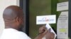 A resident copies down the Mississippi unemployment benefit website after being unable to enter the state WIN Job Center in north Jackson, Miss., April 2, 2020. 