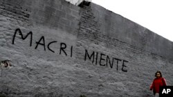 Una mujer pasa frente a una pared pintada con un mensaje que dice "Macri miente" en referencia al presidente del país, Mauricio Marci, en Buenos Aires, Argentina, el 30 de agosto de 2018.