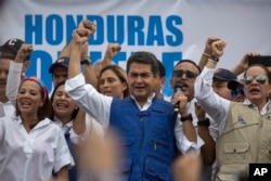 Honduran President Juan Orlando Hernandez speaks to supporters, in Tegucigalpa, Dec. 7, 2017.