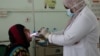 Nahla Arishi, a pediatrician, checks a woman infected with diphtheria at the al-Sadaqa teaching hospital in the southern port city of Aden, Yemen, Dec. 18, 2017. 