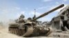 A picture taken April 8, 2018, shows Syrian army soldiers advancing in an area on the eastern outskirts of Douma, as they continue their fierce offensive to retake the last opposition holdout in Eastern Ghouta.