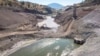 This image provided by Swiftwater Films shows a downstream view of crews working at the Iron Gate coffer dam site along the Klamath River on Tuesday, Aug. 27, 2024, in Siskiyou County, Calif.