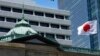 FILE - A Japanese flag flutters at the Bank of Japan headquarters in Tokyo, July 29, 2022. 