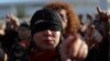 Activistas por los derechos de las mujeres con los ojos vendados participan en una protesta contra la violencia a las mujeres y contra el gobierno de Chile en Santiago.