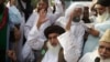 FILE - Khadim Hussain Rizvi, leader of Pakistani religious party Tehreek-i-Labaik waves to his supporters during a march, Aug. 29, 2018, in Lahore, Pakistan.