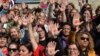 Turkish women with red points painted on their hands gather outside the Turkish parliament to protest a draft law granting muftis the right to register marriage contracts, in Ankara, Oct. 12, 2017.
