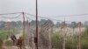 FILE - Indian Border Security Force soldiers walk near the India-Pakistan international border area at Gakhrial boder post in Akhnoor sector, about 48 kilometers (30 miles) from Jammu, India, Oct. 1, 2016.
