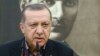 Turkey's President Recep Tayyip Erdogan, backdropped by a portrait of Turkish Republic founder Mustafa Kemal Ataturk, talks to members of the media in Istanbul, prior to his departure on a Mideast tour, Feb. 12, 2017.