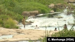 Children bath and swim in a river as people turn to unprotected sources of water in Harare, Zimbabwe, March 7, 2019.