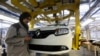 FILE - A female employee works in a Renault factory in Oran, west of Algiers.