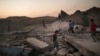 FILE - Children play on debris in a neighborhood retaken by Iraqi security forces during fighting against Islamic State militants in West Mosul, Iraq, June 25, 2017.