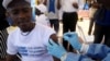FILE - A World Health Organization (WHO) worker administers a vaccination during the launch of a campaign aimed at beating an outbreak of Ebola in Mbandaka, Democratic Republic of Congo, May 21, 2018. 