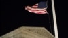 FILE - A U.S. flag flies at half-staff in front of the U.S. Supreme Court in Washington, Feb. 13, 2016.
