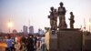 An Egyptian military convoy arrives at the Kasr El-Nile Bridge near Tahrir Square in Cairo, in order to be between supporters and opponents of ousted President Mohammed Morsi, July 5, 2013. 