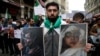 People holding pictures of victims of the airstrikes and shelling in Ghouta, a suburb of Damascus, gather during a rally outside the Russian Consulate in Istanbul, Feb. 22, 2018. 