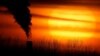 In this Monday, Feb. 1, 2021 file photo, emissions from a coal-fired power plant are silhouetted against the setting sun in Independence, Mo. A United Nations report released on Thursday, Feb. 18, 2021 says humans are making Earth a broken and increasingly unlivable planet throug