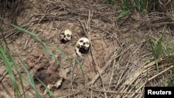 FILE - Human skulls are seen on the roadside in Tshienke near Kananga, the capital of Kasai-central province of the Democratic Republic of Congo, March 12, 2017. 