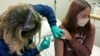  Clinical research coordinator Tammy Lewis-McCauley administers an injection to Katelyn Evans, a trial participant, as part of the hospital’s clinical trial of Pfizer's COVID-19 vaccine at Cincinnati Children’s Hospital Medical Center on Wednesday, Oct. 1