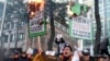 A South Korean protester holds burning placards during a rally against Japanese Prime Minister Shinzo Abe in front of the Japanese Embassy in Seoul, South Korea, Friday, Dec. 27, 2013.