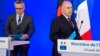 German Interior Minister Thomas de Maiziere, left, and French Interior Minister Bernard Cazeneuve arrive for a joint media conference in Paris, Aug. 23, 2016. 