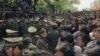 FILE - Students demonstrators scuffle with police as they try to break the guard line to march to the Tiananmen Square in Beijing, April 27, 1989. 