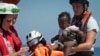 Rescuers put a life jacked on a child during a search and rescue operation conducted by SOS Mediterranee and MSF (Doctors Without Borders) NGOs, in the Mediterranean Sea, north of Libyan coast.