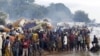 FILE - Burundian refugees gather on the shores of Lake Tanganyika in Kagunga village in Kigoma region in western Tanzania, as they wait for MV Liemba to transport them to Kigoma township, May 17, 2015. 