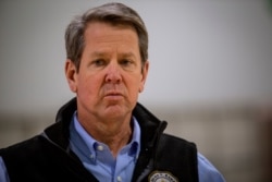 Georgia Gov. Brian Kemp listens to a question from the press during a tour of a temporary hospital at the Georgia World Congress Center on April 16, 2020, in Atlanta.