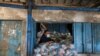 A Palestinian worker looks on as he prepares bags of food supplies at an aid distribution center run by United Nations Relief and Works Agency (UNRWA), at Beach refugee camp in Gaza City, April 7, 2021. 