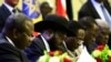 President of South Sudan, Salva Kiir signs a final power-sharing deal between South Sudanese arch-foes, Aug. 5, 2018, in Khartoum.
