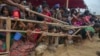 FILE - Rohingya Muslim children, who crossed over from Myanmar into Bangladesh, are squashed together as they wait to receive food handouts distributed to children and women by a Turkish aid agency at Thaingkhali refugee camp, Bangladesh, Oct. 21, 2017.