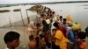Rohingya refugees wait for boat to cross a canal after crossing the border through the Naf River in Teknaf, Bangladesh, Sept. 7, 2017.