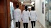 FILE - Medical workers walk at Severance Hospital in Seoul, South Korea, Feb.21, 2024.
