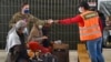 FILE - Afghan refugees are seated as they are being processed inside Hangar 5 at Ramstein Air Base in Germany, Sept. 8, 2021.