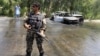 An Afghan security force stands guard at the site of a suicide attack in Jalalabad city, Afghanistan July 10, 2018. 