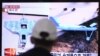 FILE - A man watches a TV news program showing unmanned drones, at the Seoul Railway Station in Seoul, South Korea, Wednesday, April 2, 2014