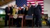 President Barack Obama, surrounded by members of Congress, signs the Farm Bill, Feb. 7, 2014, at Michigan State University in East Lansing, Michigan.