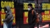 FILE - Sale and going-out-of-business signs are displayed in a store window in the Brooklyn borough of New York City, Dec. 1, 2020. 
